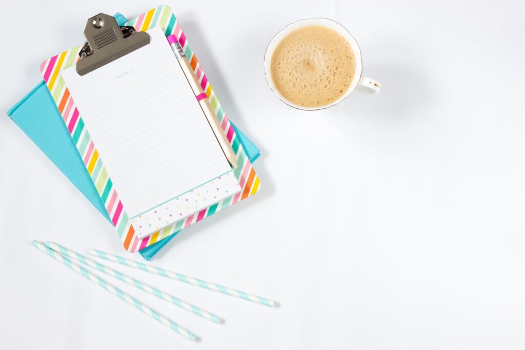 white ceramic teacup beside grey paper clip